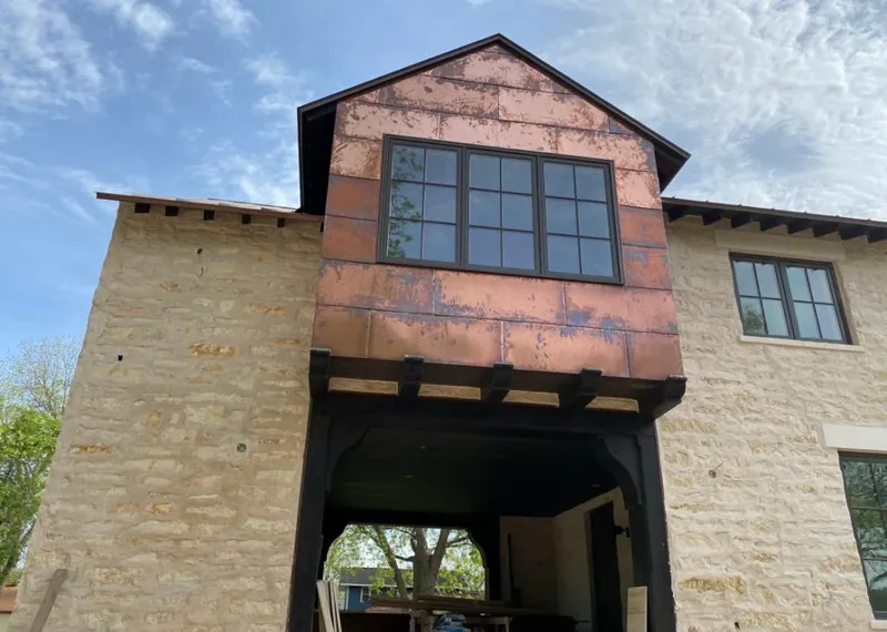Copper metal panel facade on a stone building for Metal Roof Coating in Delhi Hills